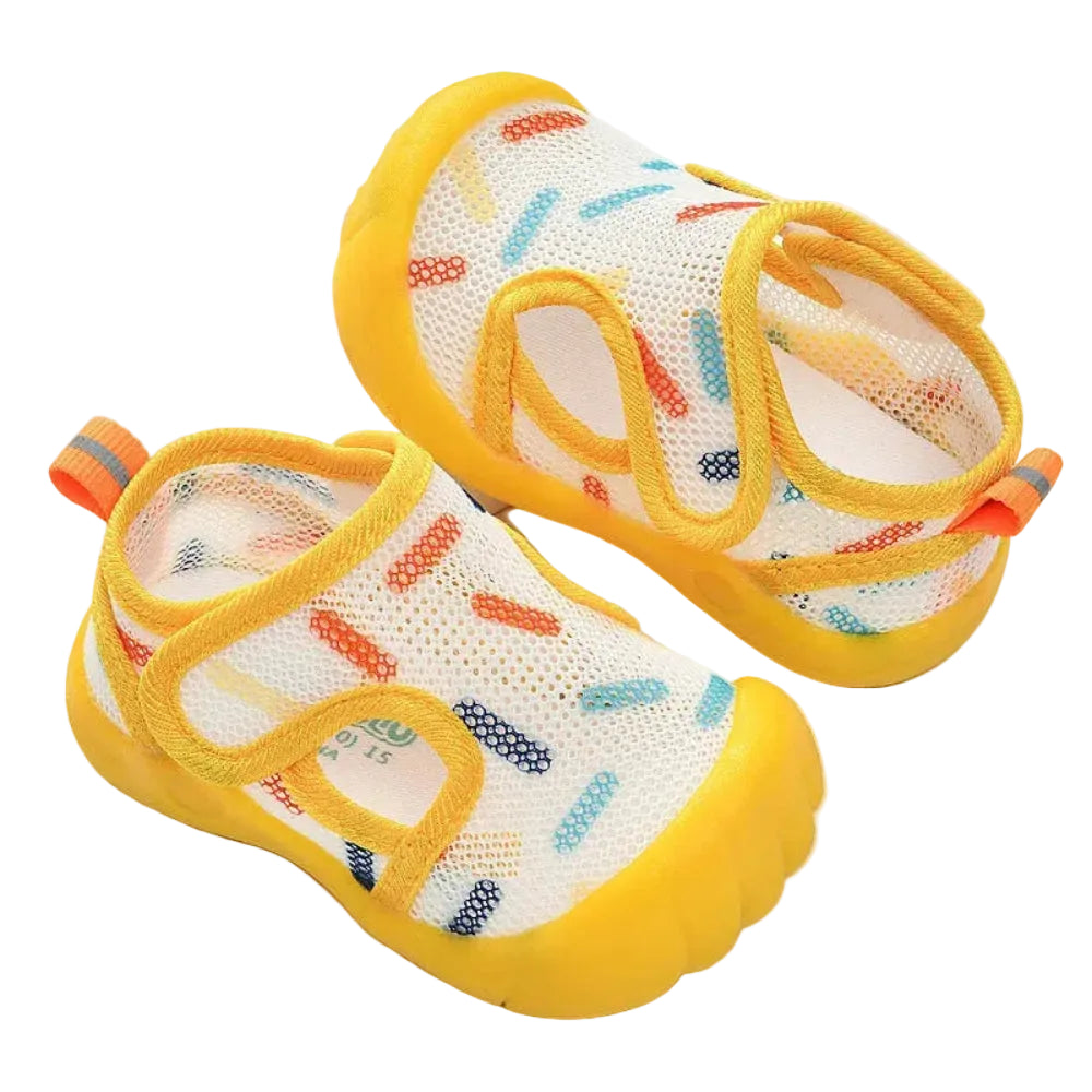 Colorful children's shoes with yellow soles on a white background