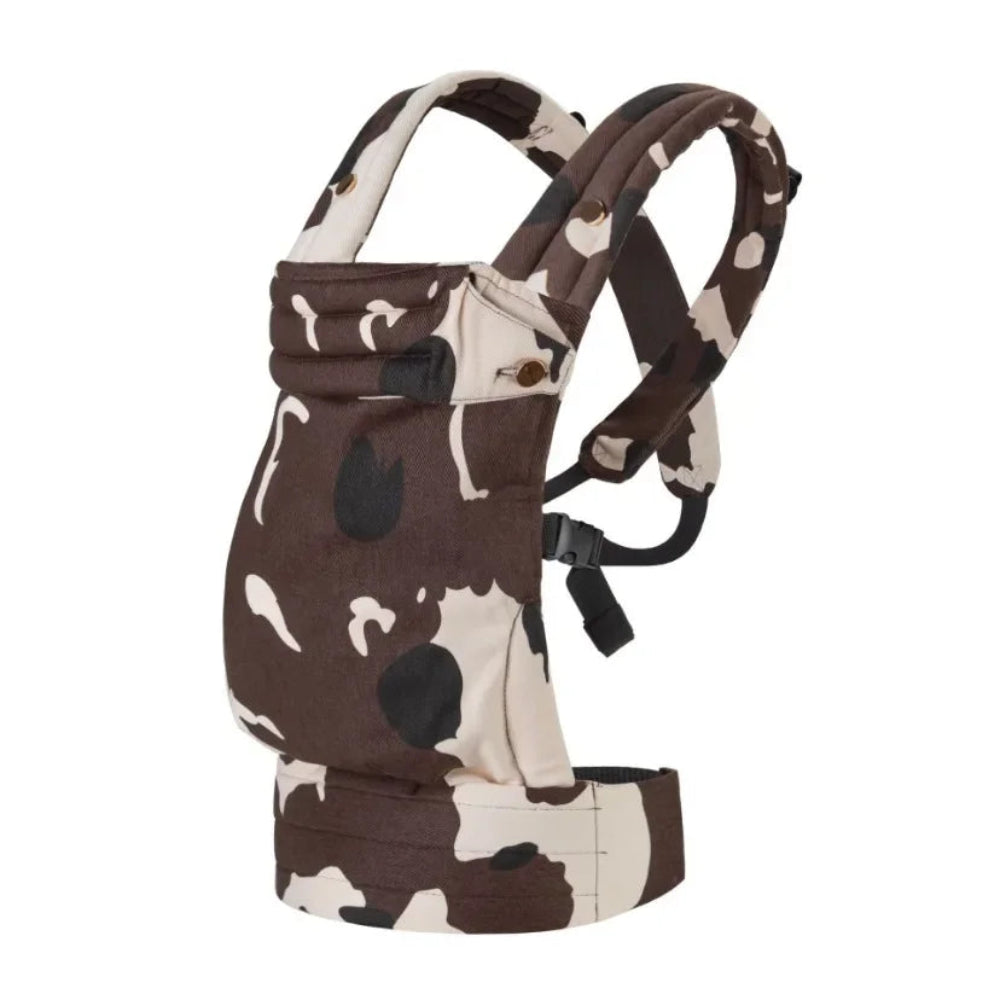 Baby carrier with cow print design on a white background